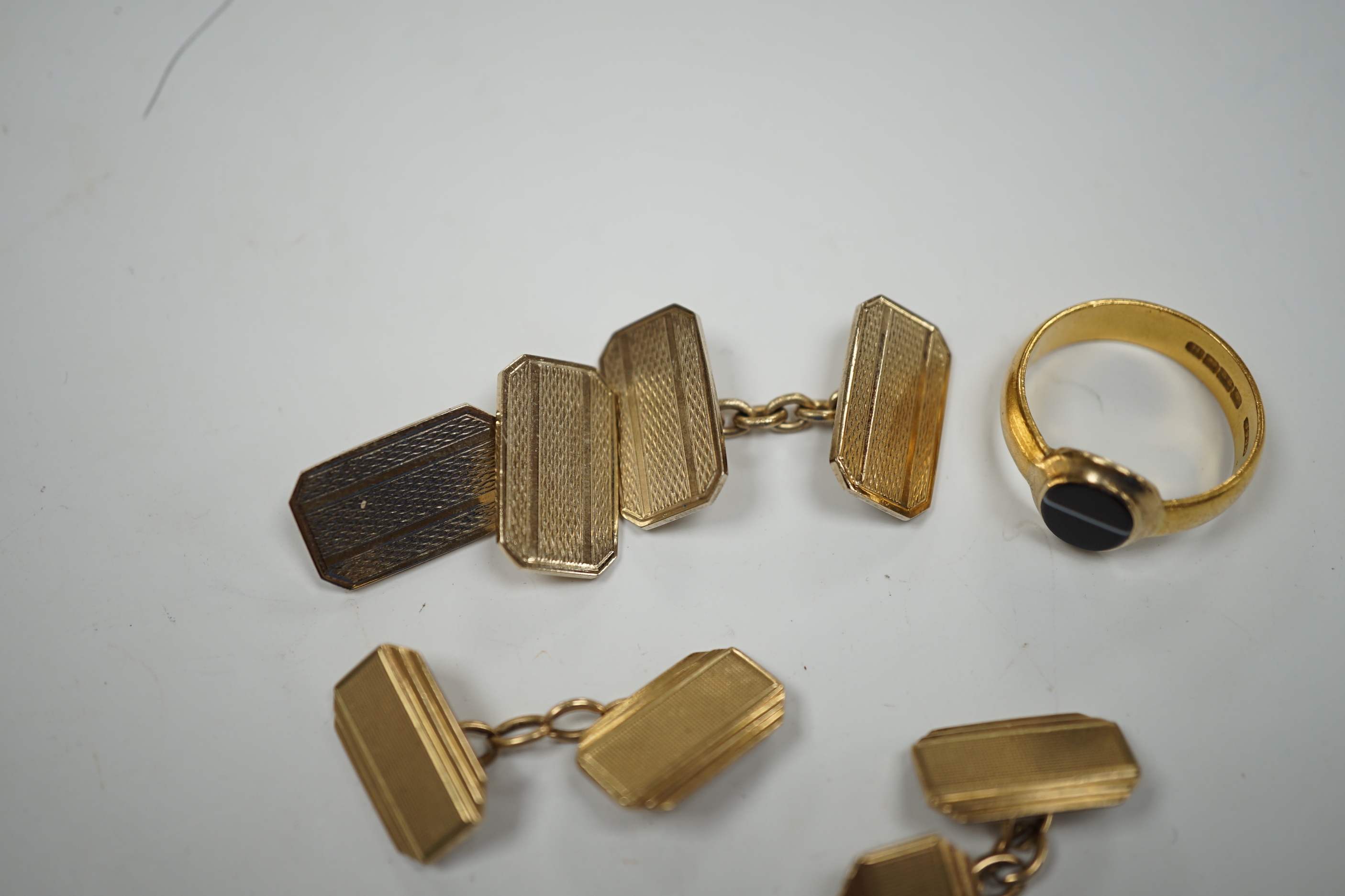 A 1930's part 22ct gold and banded black onyx set signet ring, (the ring head later associated), size Q/R, gross weight 6.8 grams, a pair of engine turned 9ct gold cufflinks, 8.5 grams and one other pair of cufflinks.